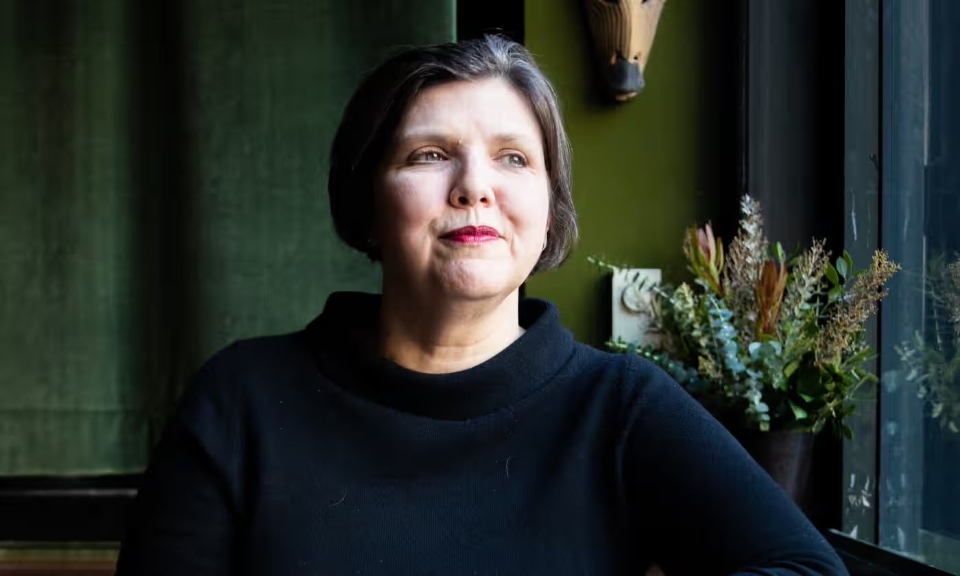 Jenny Offill in a black mockneck shirt and short hair